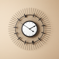 Orologio Clock design sunburst con raggi metallici neri e specchio centrale