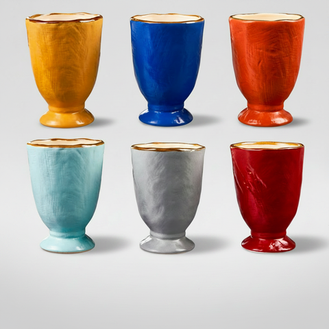 Tazze ceramica colorate su sfondo grigio con ombra sottile