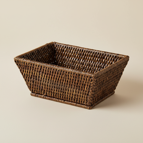 Cestino rettangolare in rattan intrecciato su sfondo beige