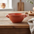 Ciotola zuppa terracotta ambientata su tavolo in legno