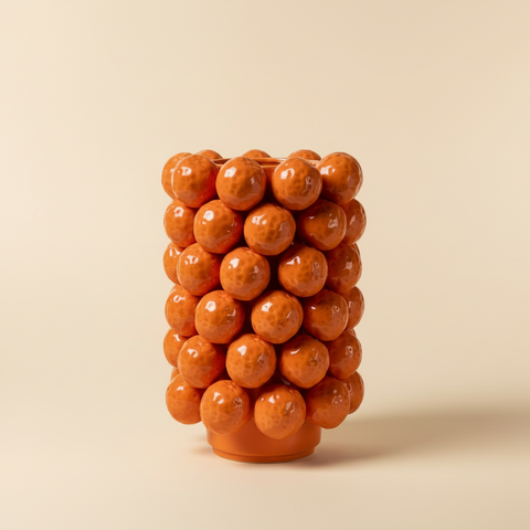 Vaso ceramica bolle arancio sfondo beige